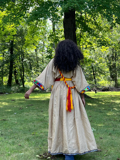 Traditional Dress in Beige with Red, Yellow, and Blue Accents